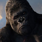 Closeup of King Kong sillouetted against the sky.